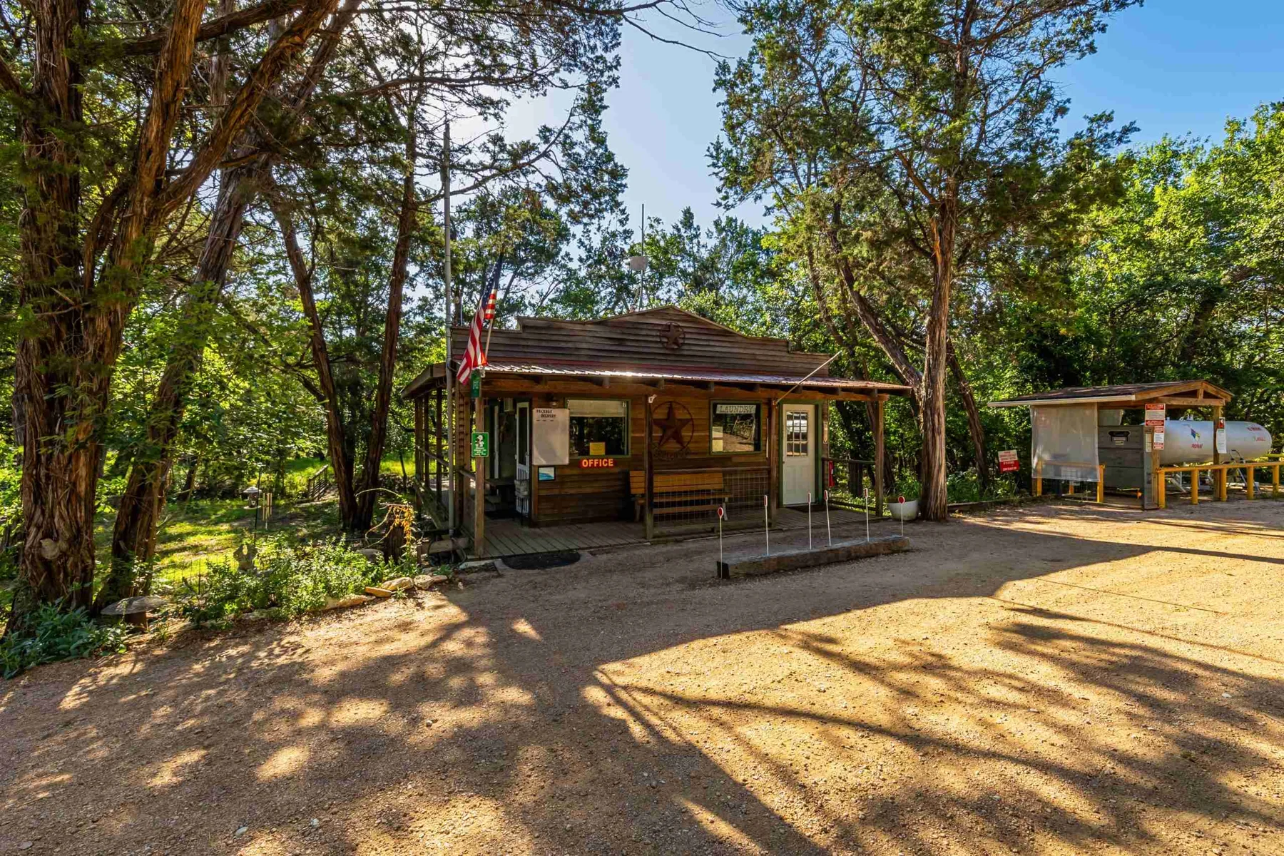 The park building under mature trees